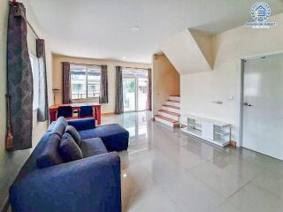 Modern living room with ample seating and bright natural light