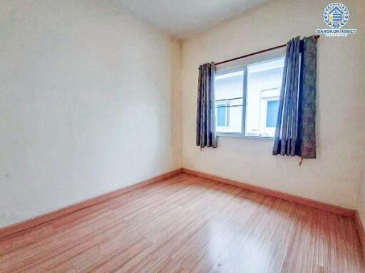 Bright empty bedroom with wooden flooring