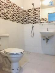 Modern Bathroom with White Fixtures and Mosaic Tile Accents