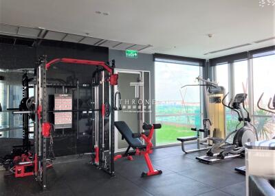 Modern home gym with exercise equipment and city view