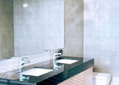 Modern bathroom with large countertop and sleek design