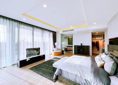 Spacious and modern bedroom with en-suite bathroom and large windows