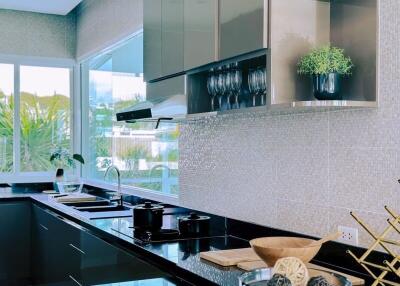 Modern kitchen with black countertops and stainless steel appliances