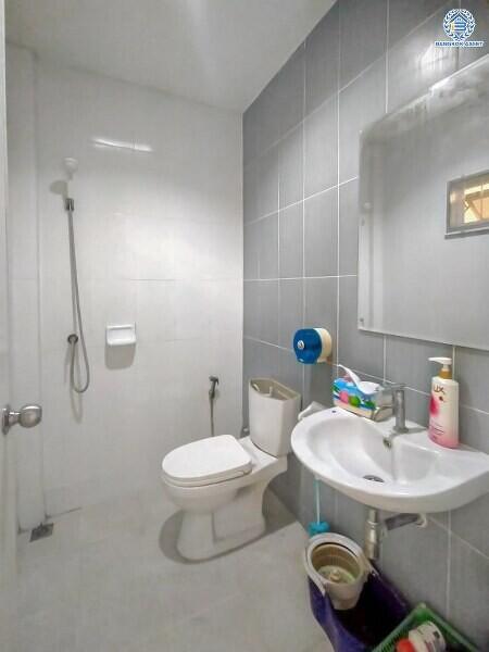 Modern bathroom with white fixtures and grey tiles