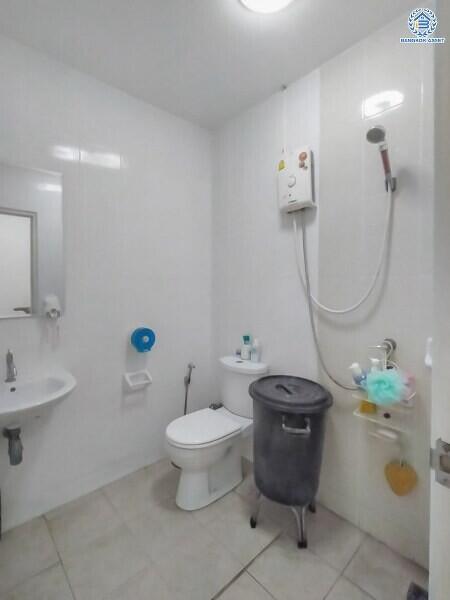 White modern bathroom with toilet, shower, and sink