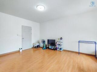 Spacious and brightly lit empty living room with laminate flooring