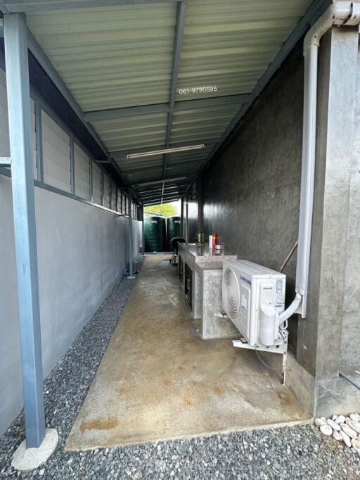 Side passage of a house showing AC unit and exterior utilities