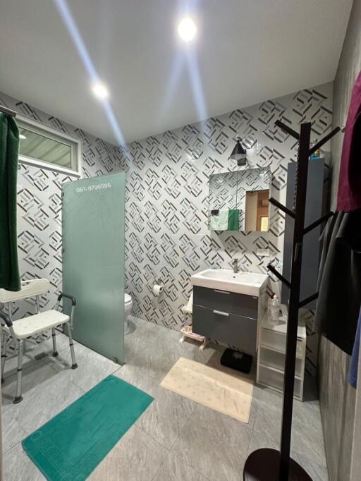 Modern bathroom with patterned wallpaper and stylish fixtures