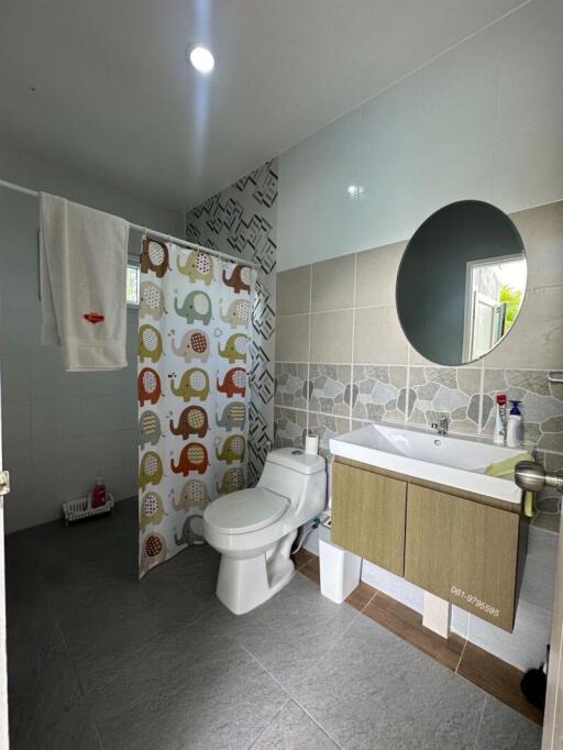 Modern bathroom with shower curtain and vanity