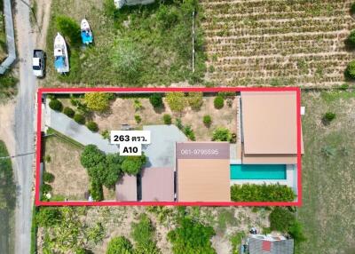 Aerial view of a residential property with swimming pool and garden