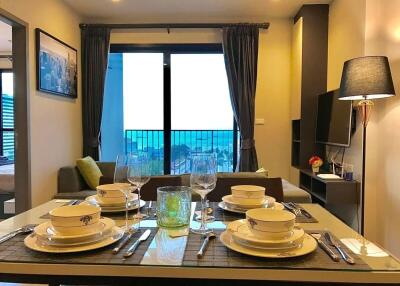 Elegantly set dining table in a modern living space with balcony access