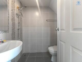 Modern bathroom with shower and ceramic tiles