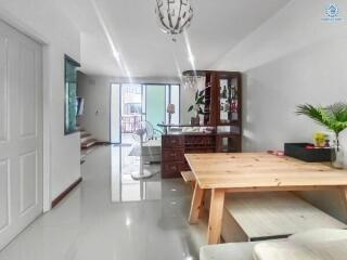 Spacious and well-lit living room with contemporary furniture and balcony access