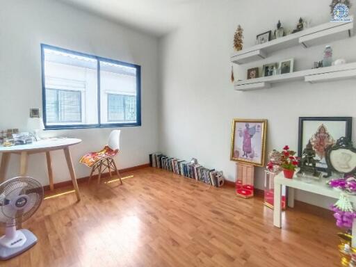 Bright bedroom with large windows and hardwood floors