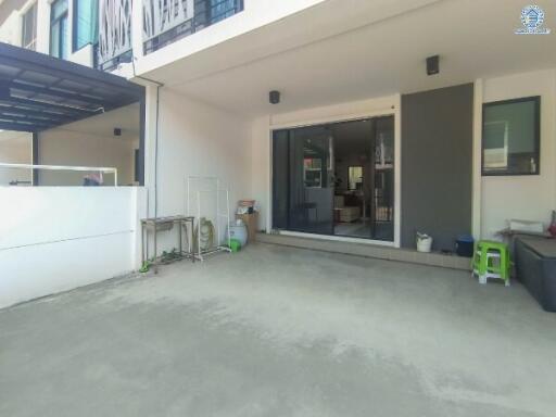 Exterior view of a modern building entrance with spacious driveway