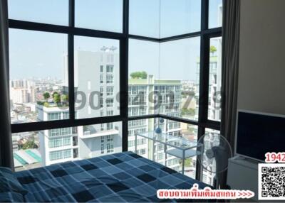 Modern bedroom with large windows and city view