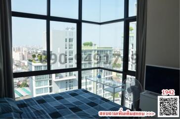 Modern bedroom with large windows and city view