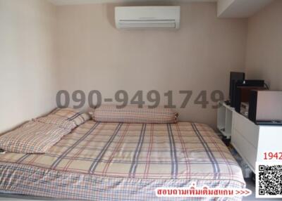 Cozy bedroom with large bed and modern air conditioning unit