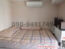 Cozy bedroom with large bed and modern air conditioning unit