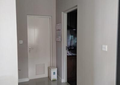 Compact hallway leading to a kitchen