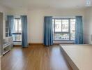 Spacious living room with natural light and hardwood floors