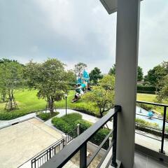 Spacious balcony overlooking community park with playground and pool