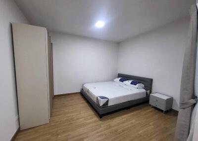 Spacious bedroom with hardwood floors and minimalistic decor
