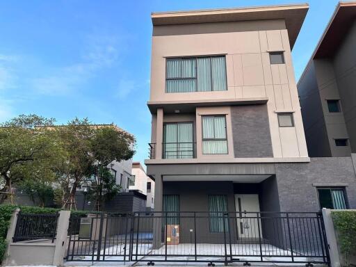 Modern two-story family house with a gated entrance