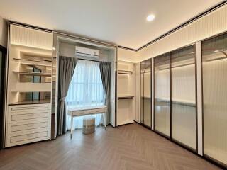Spacious bedroom with large wardrobe and ample storage space