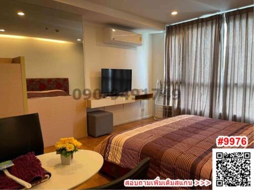Cozy bedroom with modern amenities and ample lighting