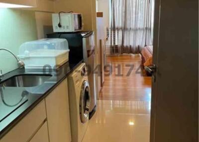 Modern kitchen with glossy flooring and integrated appliances