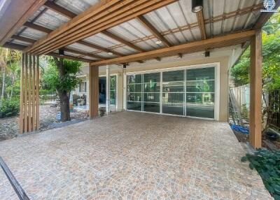 Spacious covered patio overlooking the garden with large sliding glass doors