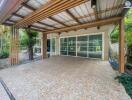 Spacious covered patio overlooking the garden with large sliding glass doors