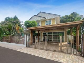 Suburban two-story house with a carport and landscaped front yard