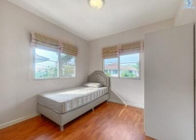 Bright and airy bedroom with single bed and hardwood floors