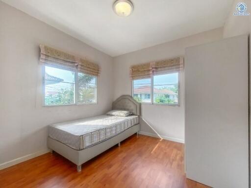 Bright and airy bedroom with single bed and hardwood floors