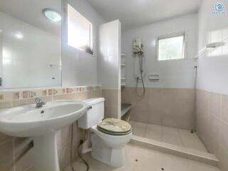 Bright and clean tiled bathroom with modern fixtures