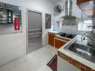 Modern kitchen with stainless steel appliances and tile backsplash