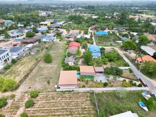 Aerial view of a residential area showing an array of buildings with various roof colors and surrounding greenery