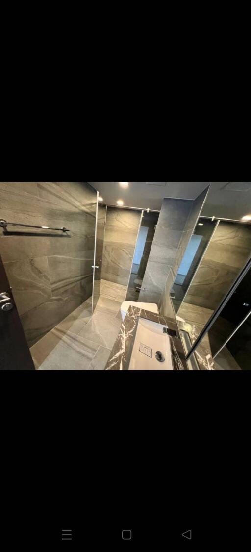 Modern bathroom with glass shower and marble finish