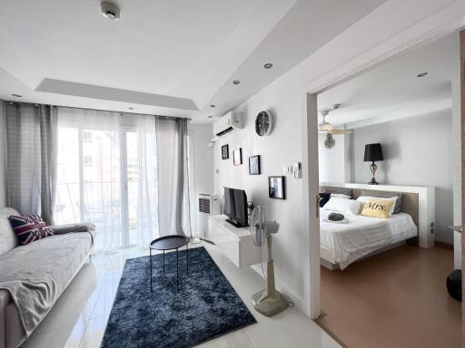 Modern bedroom with living space and balcony access