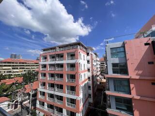 Exterior view of urban apartment buildings under blue sky