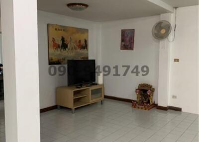 Spacious living room with tiled flooring and modern amenities