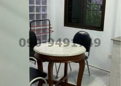 Compact dining area with table and chairs near a window