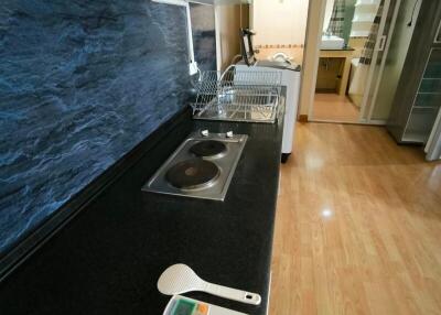 Modern kitchen with stainless steel appliances and black countertop