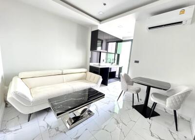 Modern living room with white furniture and marble flooring