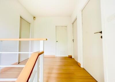 Bright and spacious hallway with hardwood floors and natural light