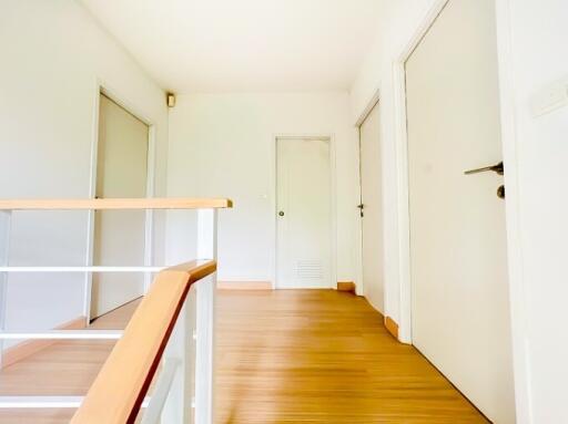 Bright and spacious hallway with hardwood floors and natural light