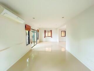Spacious and Bright Empty Room with Large Windows and Tiled Flooring