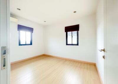 Bright and Empty Bedroom with Wooden Floor